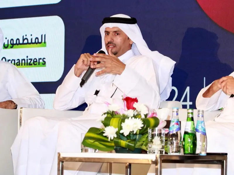 A panel of speakers seated on the conference stage, 2024.