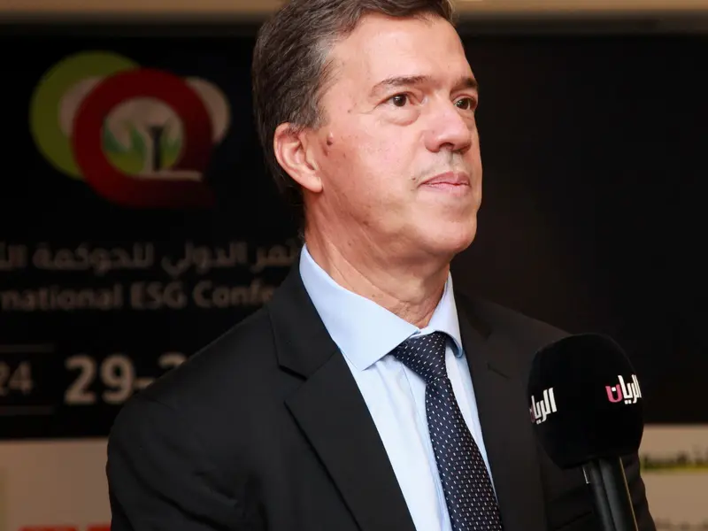 A participant speaking to a broadcaster’s microphone, 2024.