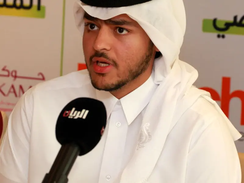 A participant speaking to a broadcaster’s microphone, 2024.