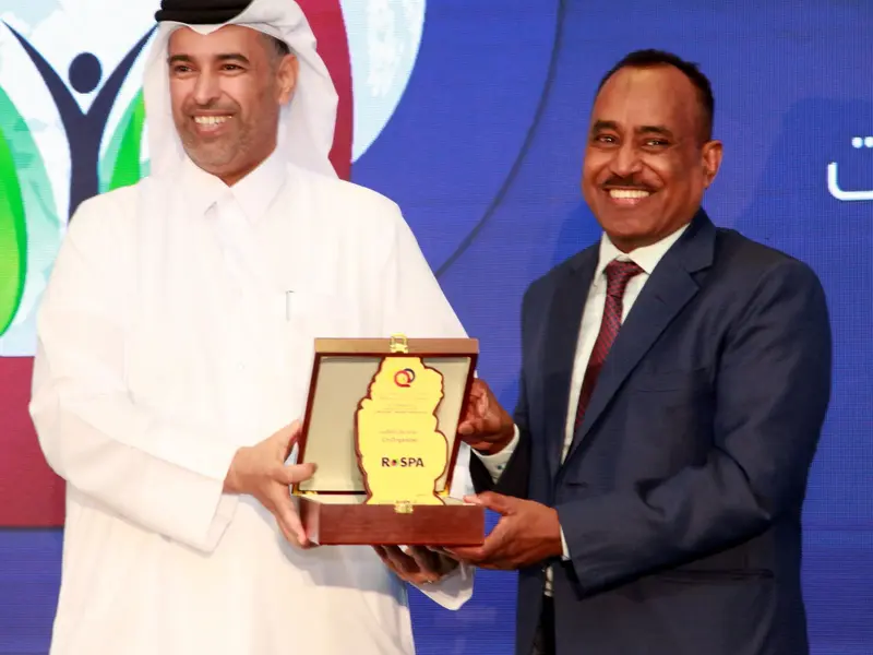 A commemorative shield presented on the conference stage, 2024.
