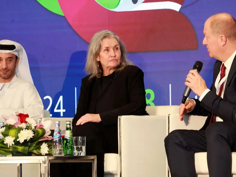 A panel of speakers seated on the conference stage, 2024.
