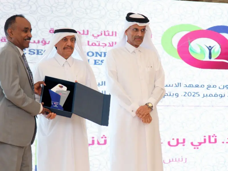 A commemorative shield presented on the conference stage, 2025.