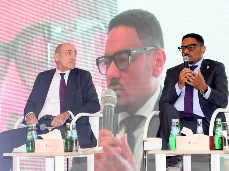 A panel of speakers seated on the conference stage, 2025.