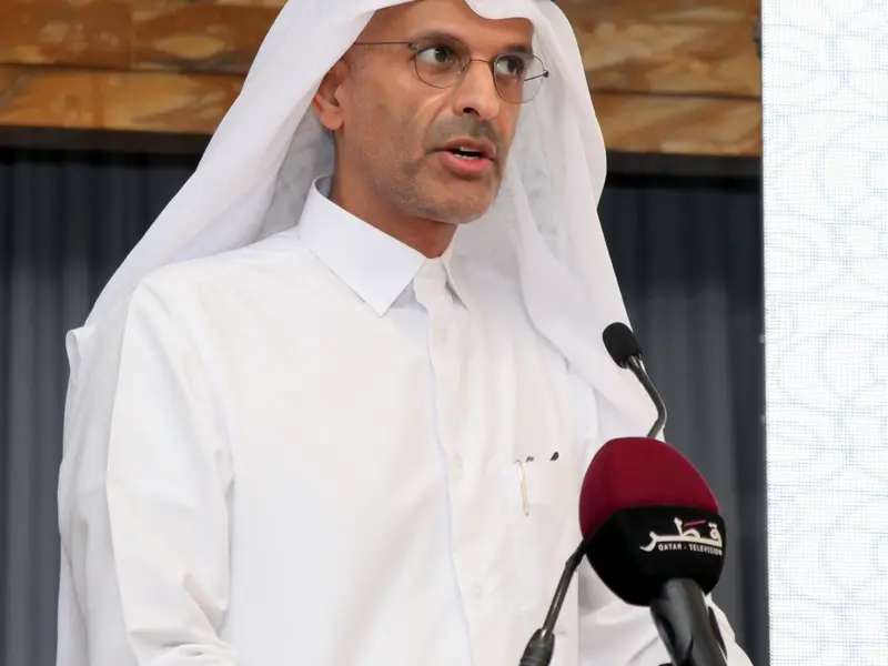 A speaker addressing the hall from the lectern, 2025.
