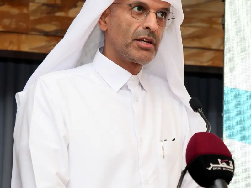 A speaker addressing the hall from the lectern, 2025.