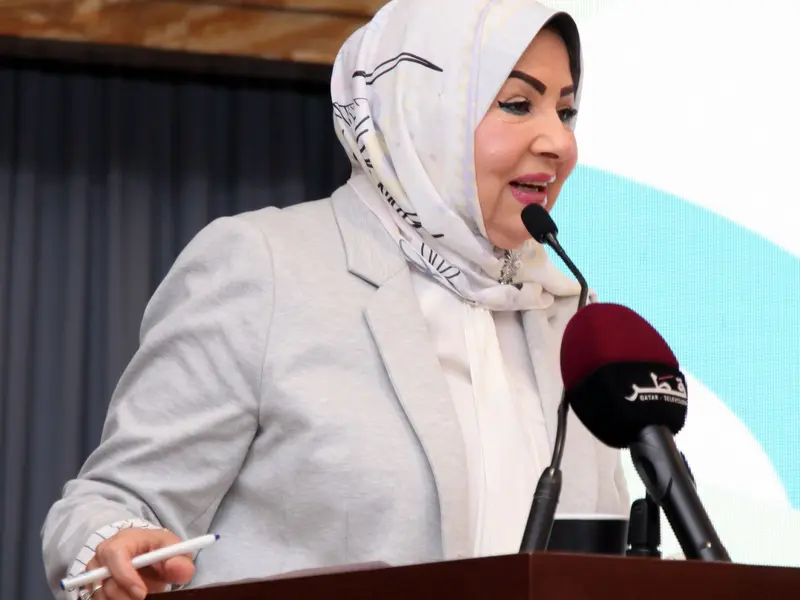 A speaker addressing the hall from the lectern, 2025.