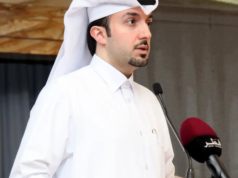 A speaker addressing the hall from the lectern, 2025.