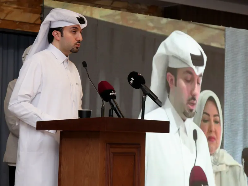 A speaker addressing the hall from the lectern, 2025.