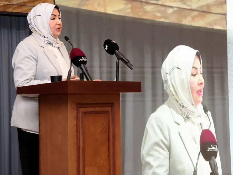 A speaker addressing the hall from the lectern, 2025.