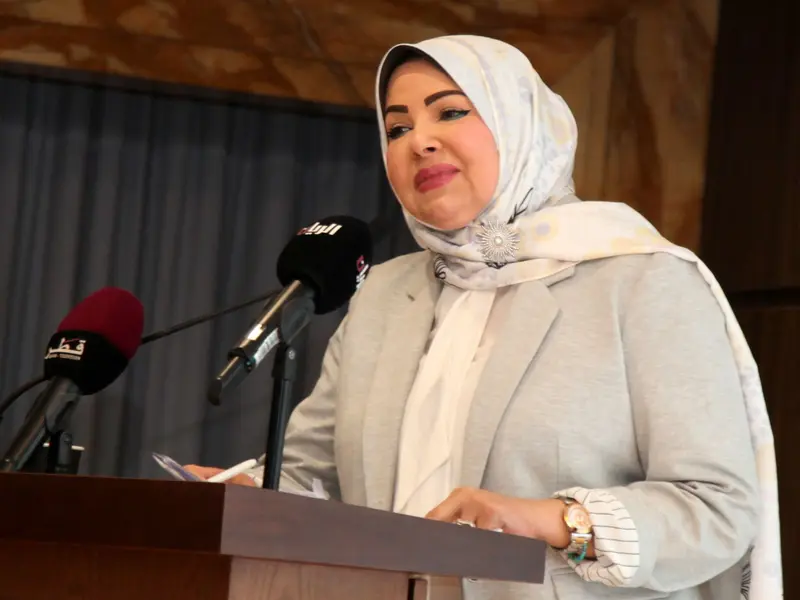 A speaker addressing the hall from the lectern, 2025.