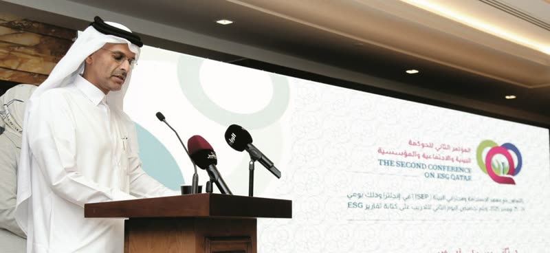 A Qatari official speaks at the lectern in front of the branded 'The Second Conference on ESG Qatar' screen.