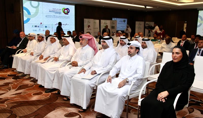 Wide view of the seated audience at the opening of the Second Conference on ESG Qatar 2025, the branded title slide and sponsor banners visible across the hall.