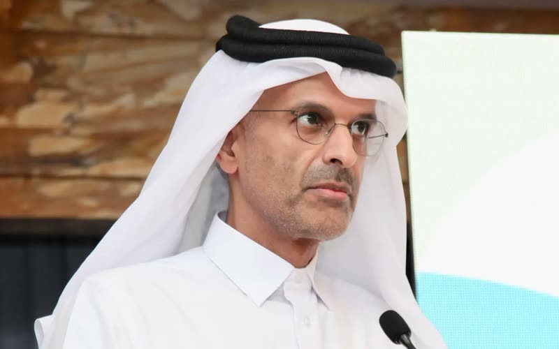 A Qatari official addresses the ESG Qatar 2025 conference from the lectern microphone.